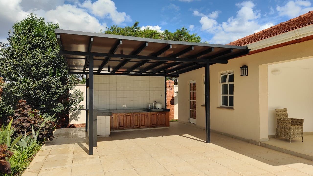 Tensile shade structure over a residential garden patio in Nairobi
