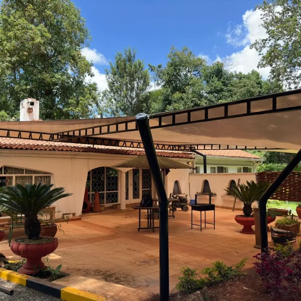 Completed cantilever tensile membrane canopy over a paved patio by Diamond Canopies