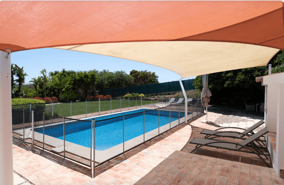 Tensioned shade sail over a swimming pool at a resort in Kenya